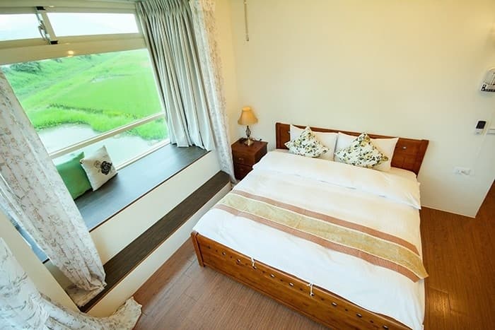 202 Riverside View Double Room bed and field view